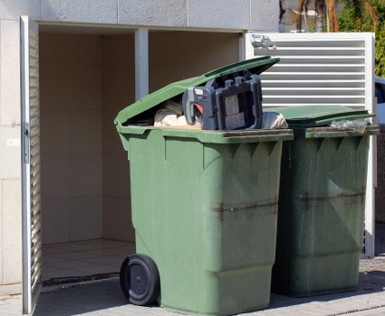 Supervisor conducting a safety audit at a skip hire site